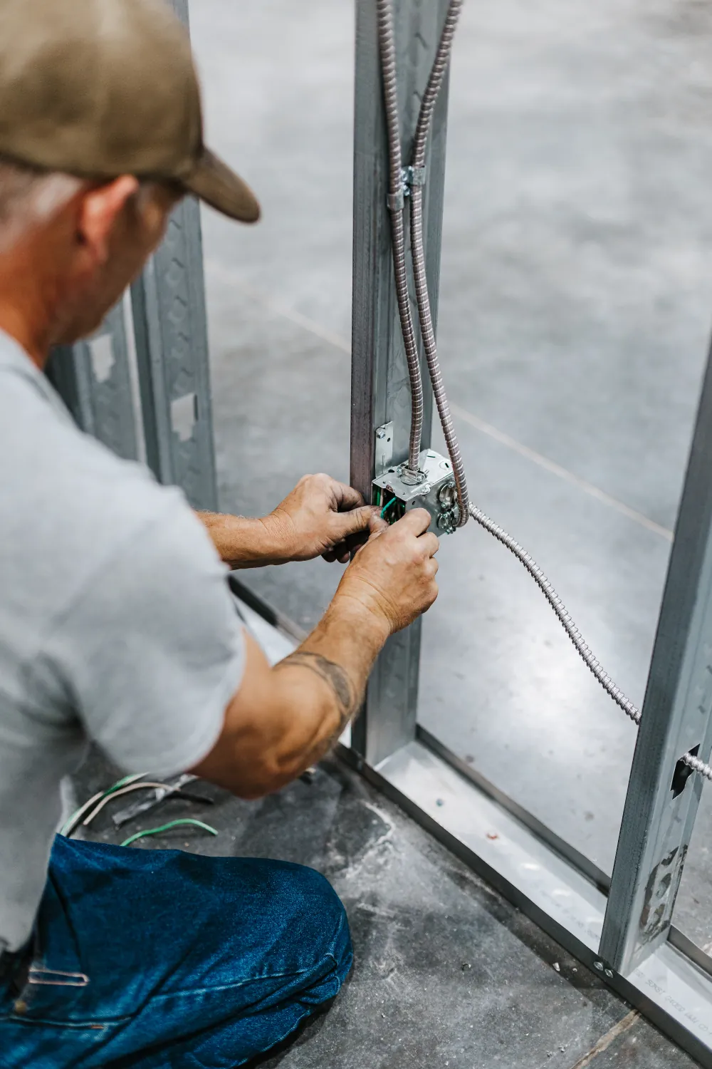A Midway Electric electrician terminating wiring in a junction box